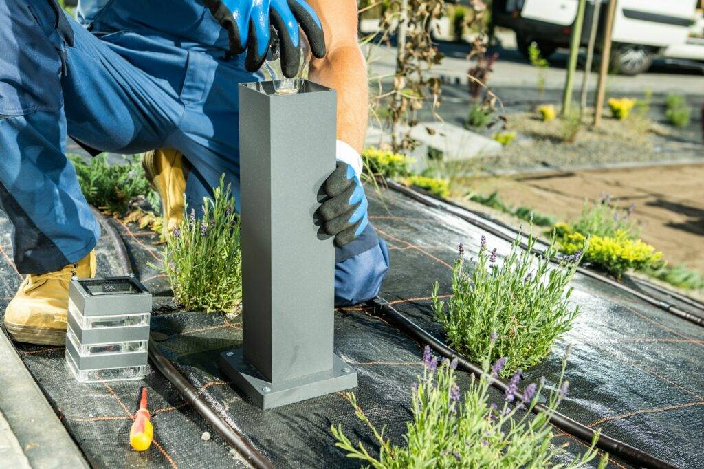 Landscaping Worker Installing Backyard Lighting