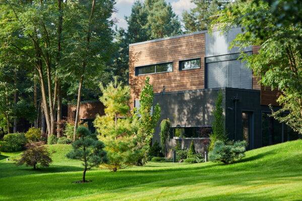 Modern wooden cottage house built in pine forest